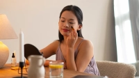 japanese woman applying skincare product - 1